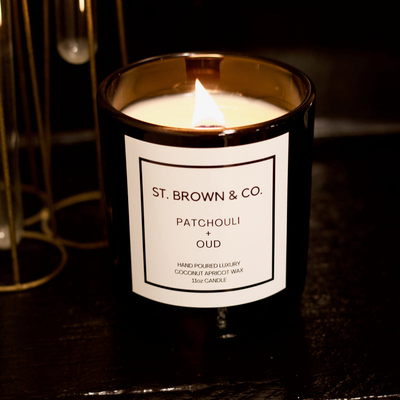Candle with a label reading 'St. Brown & Co.' on a dark background